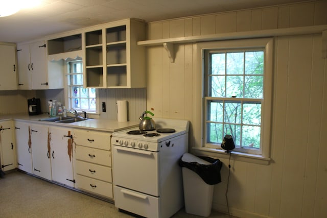 7 Maple St, Milbridge, ME 04658 - kitchen with white range with electric cooktop, open shelves, white cabinets, and light countertops
