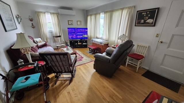 32 Highland Ave, Lincoln, ME 04457 - living area featuring an AC wall unit and wood finished floors