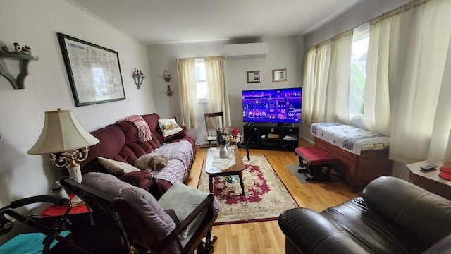 32 Highland Ave, Lincoln, ME 04457 - living room with a wall unit AC and light wood finished floors