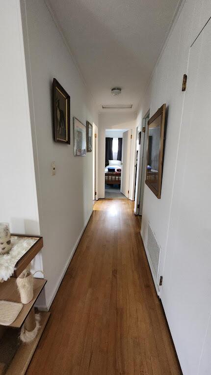 32 Highland Ave, Lincoln, ME 04457 - corridor with wood finished floors and ornamental molding