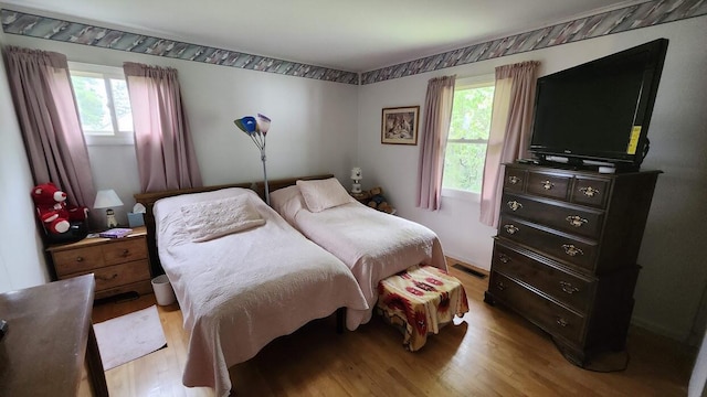 32 Highland Ave, Lincoln, ME 04457 - bedroom featuring light wood-type flooring and multiple windows