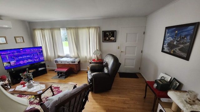 32 Highland Ave, Lincoln, ME 04457 - living area with light wood-style floors and a wall unit AC