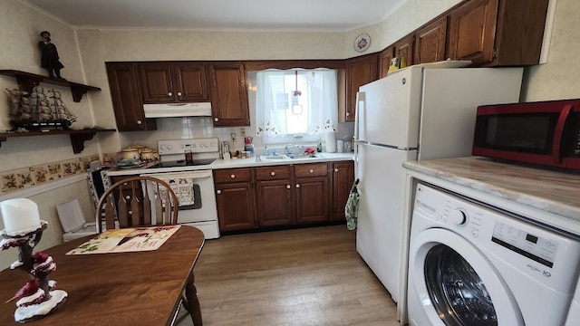 32 Highland Ave, Lincoln, ME 04457 - kitchen featuring washer / clothes dryer, under cabinet range hood, electric stove, light wood finished floors, and light countertops