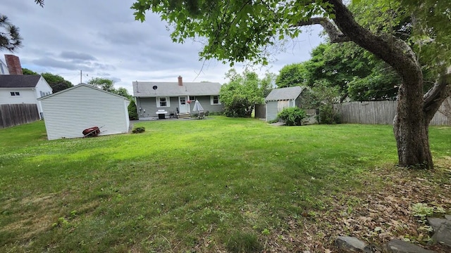 32 Highland Ave, Lincoln, ME 04457 - fenced backyard with a storage unit and entry steps