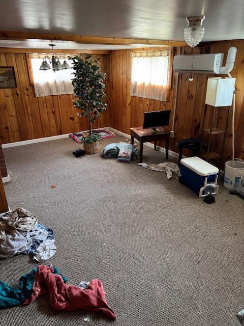 13 Frost Hill Ave, Lisbon, ME 04252 - sitting room with a wall mounted AC, wooden walls, and carpet flooring