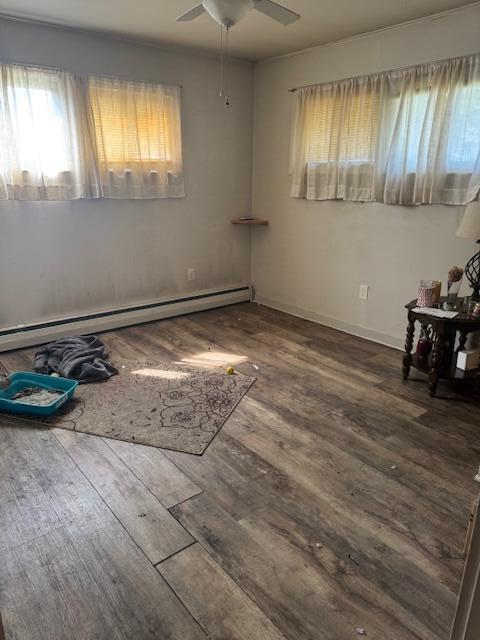 13 Frost Hill Ave, Lisbon, ME 04252 - unfurnished room with a baseboard heating unit, wood finished floors, and a ceiling fan