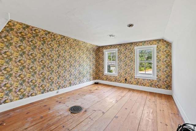 48 Elm St, Newfield, ME 04095 - spare room featuring light wood-style floors, wallpapered walls, and vaulted ceiling