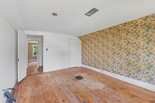 48 Elm St, Newfield, ME 04095 - unfurnished room with wallpapered walls, light wood-style floors, and lofted ceiling