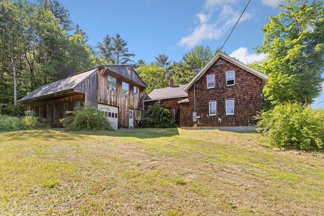 48 Elm St, Newfield, ME 04095 - view of front facade with a front yard, an outbuilding, and a chimney