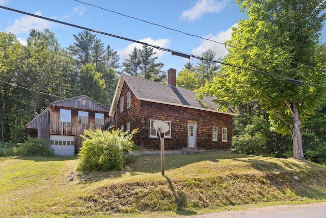 48 Elm St, Newfield, ME 04095 - view of front of property with a shingled roof, a chimney, a detached garage, and a front lawn