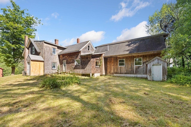 48 Elm St, Newfield, ME 04095 - back of property featuring a storage shed, a lawn, and a chimney