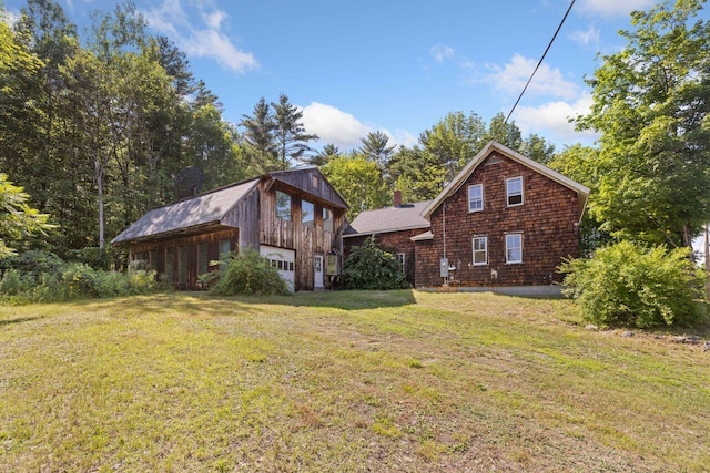 48 Elm St, Newfield, ME 04095 - rear view of property featuring an outbuilding, a lawn, a chimney, and a detached garage