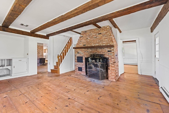 48 Elm St, Newfield, ME 04095 - unfurnished living room featuring beam ceiling, a brick fireplace, hardwood / wood-style floors, a baseboard heating unit, and stairway