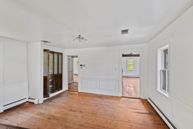 48 Elm St, Newfield, ME 04095 - spare room with a baseboard heating unit, light wood-style floors, and baseboard heating