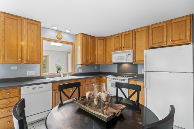 38 Tarr Ave, Lewiston, ME 04240 - kitchen with white appliances, dark countertops, recessed lighting, brown cabinets, and light tile patterned flooring