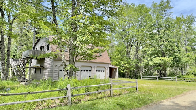 270 Grant Rd, Sullivan, ME 04664 - view of home's exterior featuring a gambrel roof, a deck, stairway, and an attached garage