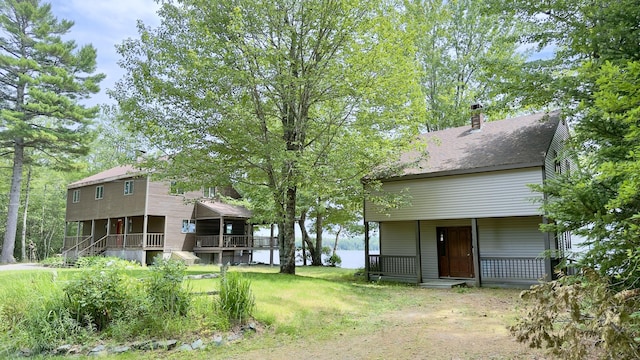 270 Grant Rd, Sullivan, ME 04664 - rear view of house with covered porch and a chimney