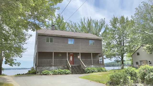 270 Grant Rd, Sullivan, ME 04664 - view of front of house with covered porch, a chimney, and a water view