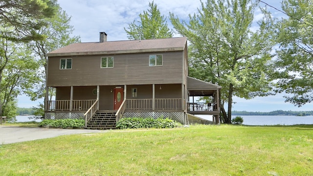 270 Grant Rd, Sullivan, ME 04664 - view of front of house featuring a porch, a chimney, a front yard, and a water view