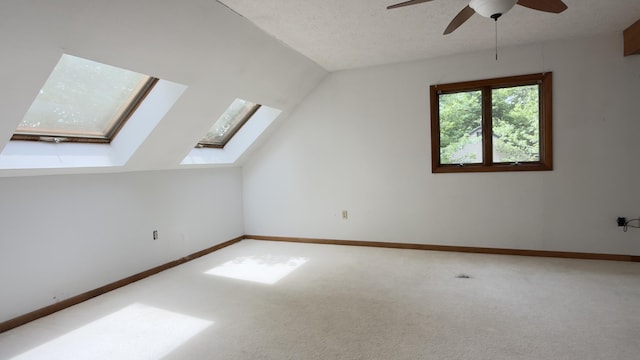 270 Grant Rd, Sullivan, ME 04664 - additional living space with plenty of natural light, a skylight, ceiling fan, carpet floors, and vaulted ceiling