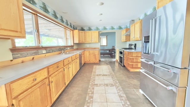 270 Grant Rd, Sullivan, ME 04664 - kitchen with stainless steel appliances, light brown cabinetry, light tile patterned flooring, light countertops, and under cabinet range hood