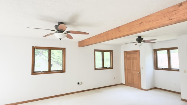 270 Grant Rd, Sullivan, ME 04664 - empty room with ceiling fan, plenty of natural light, light colored carpet, and beam ceiling