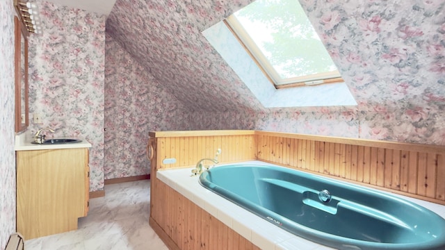270 Grant Rd, Sullivan, ME 04664 - bathroom featuring a baseboard heating unit, wallpapered walls, a garden tub, vanity, and vaulted ceiling