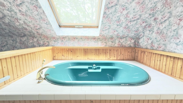 270 Grant Rd, Sullivan, ME 04664 - full bath with wallpapered walls, a skylight, a wainscoted wall, and a bathtub