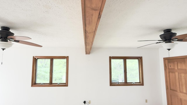 270 Grant Rd, Sullivan, ME 04664 - detailed view of a ceiling fan, a textured ceiling, and beam ceiling