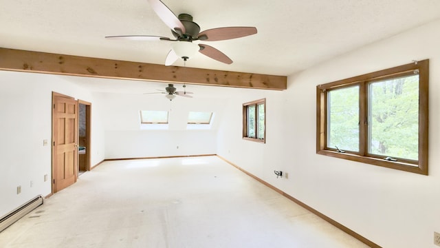 270 Grant Rd, Sullivan, ME 04664 - spare room featuring a baseboard heating unit, a skylight, light carpet, beamed ceiling, and a ceiling fan