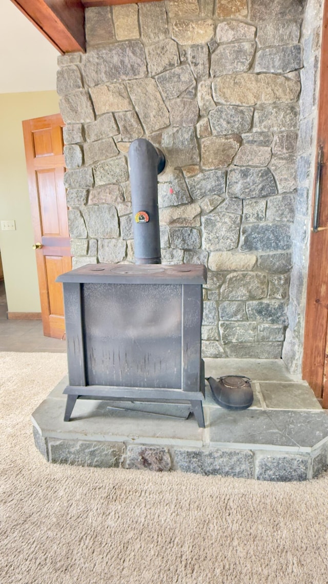 270 Grant Rd, Sullivan, ME 04664 - detailed view of a wood stove and beamed ceiling