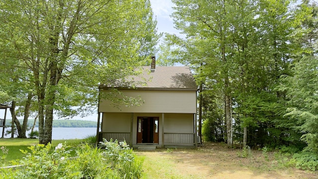 270 Grant Rd, Sullivan, ME 04664 - view of front of house with a chimney, covered porch, and a water view