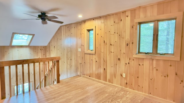 270 Grant Rd, Sullivan, ME 04664 - additional living space with a skylight, wood finished floors, wooden walls, a ceiling fan, and lofted ceiling
