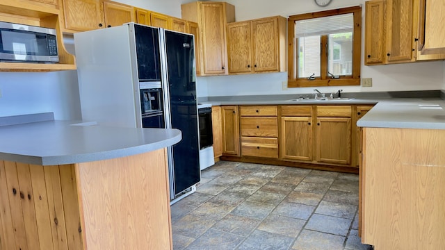 270 Grant Rd, Sullivan, ME 04664 - kitchen with stainless steel microwave, stone tile floors, range with electric stovetop, light countertops, and black refrigerator with ice dispenser