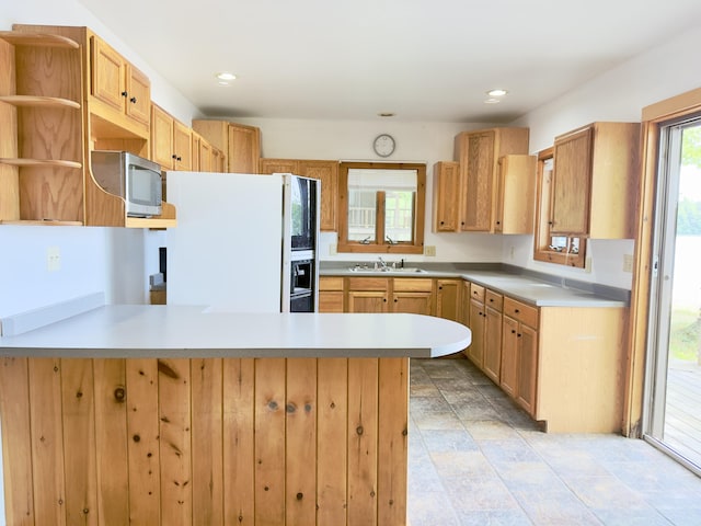 270 Grant Rd, Sullivan, ME 04664 - kitchen featuring freestanding refrigerator, stainless steel microwave, a peninsula, light countertops, and open shelves