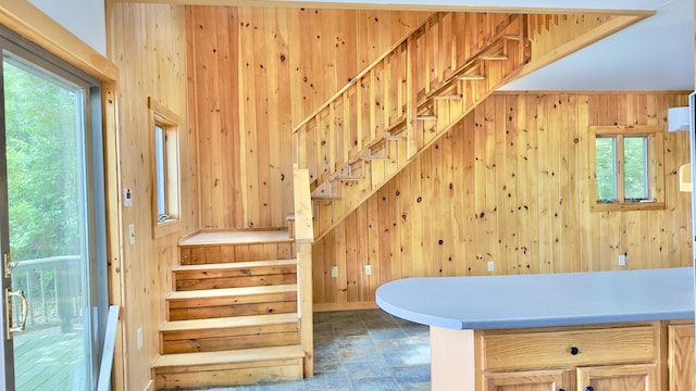 270 Grant Rd, Sullivan, ME 04664 - stairs featuring wood walls, plenty of natural light, and stone finish flooring