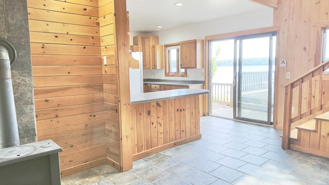 270 Grant Rd, Sullivan, ME 04664 - kitchen with wooden walls, recessed lighting, light countertops, a peninsula, and a wood stove