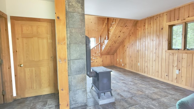270 Grant Rd, Sullivan, ME 04664 - additional living space with stone tile flooring, wooden walls, stairs, and a wood stove