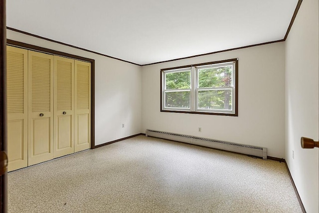 329 Reed Rd, Windsor, ME 04363 - unfurnished bedroom featuring a baseboard heating unit, crown molding, and a closet