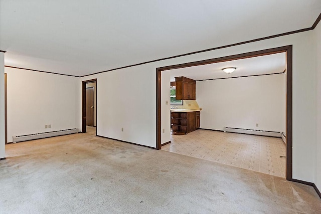 329 Reed Rd, Windsor, ME 04363 - spare room with baseboard heating, light colored carpet, and crown molding