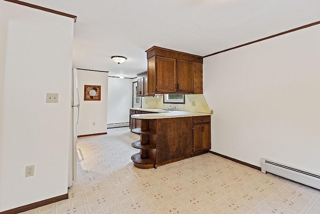 329 Reed Rd, Windsor, ME 04363 - kitchen featuring a baseboard radiator, light flooring, light countertops, a peninsula, and a baseboard heating unit