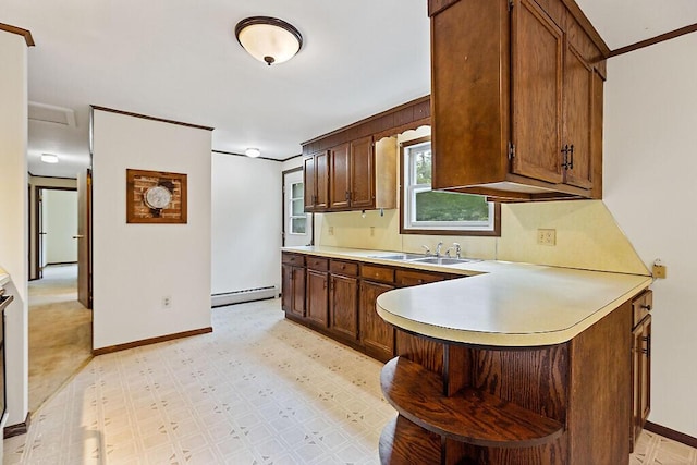 329 Reed Rd, Windsor, ME 04363 - kitchen featuring a baseboard heating unit, light countertops, a peninsula, and light flooring