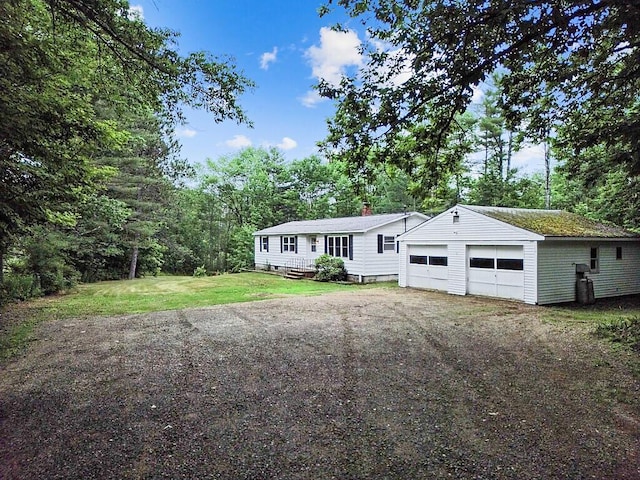 329 Reed Rd, Windsor, ME 04363 - manufactured / mobile home featuring a front lawn, a garage, and a chimney