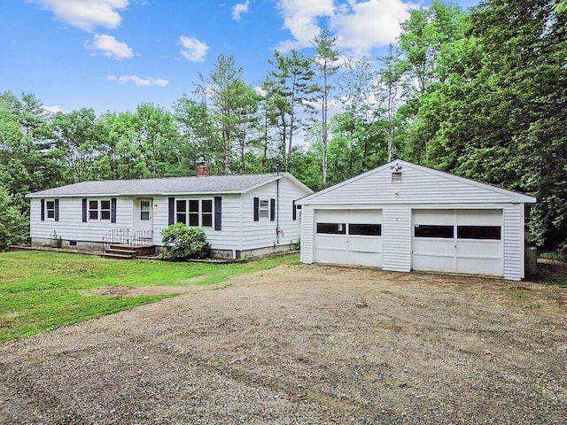 329 Reed Rd, Windsor, ME 04363 - view of front of house featuring a garage, a chimney, an outbuilding, and view of wooded area