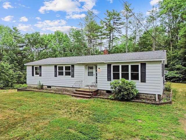 329 Reed Rd, Windsor, ME 04363 - single story home with a front lawn, a shingled roof, a chimney, and view of wooded area