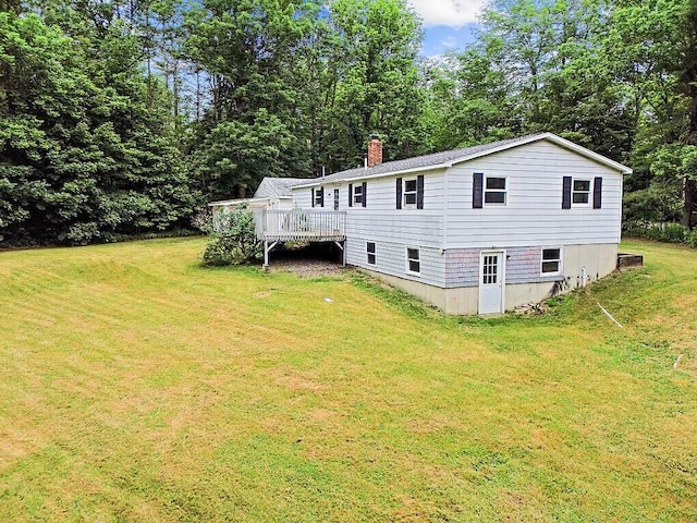 329 Reed Rd, Windsor, ME 04363 - rear view of house with a chimney, a deck, and a lawn