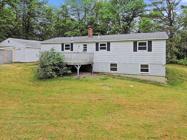 329 Reed Rd, Windsor, ME 04363 - back of property with a wooden deck, a lawn, a chimney, and an outbuilding