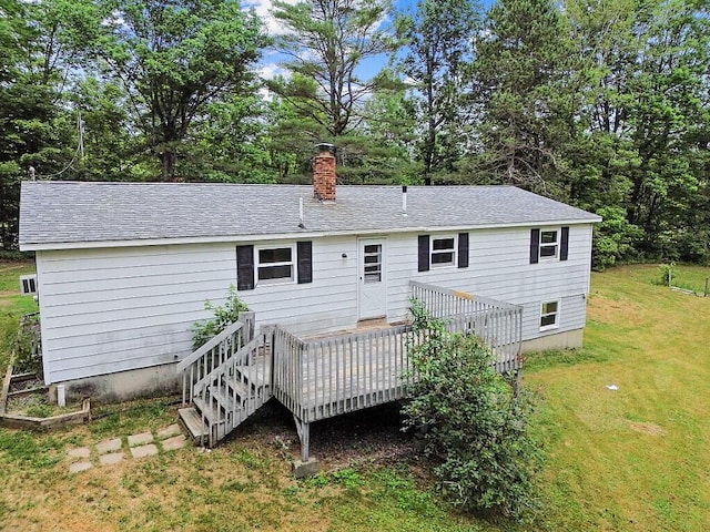 329 Reed Rd, Windsor, ME 04363 - rear view of house featuring a yard, a deck, a chimney, and view of scattered trees