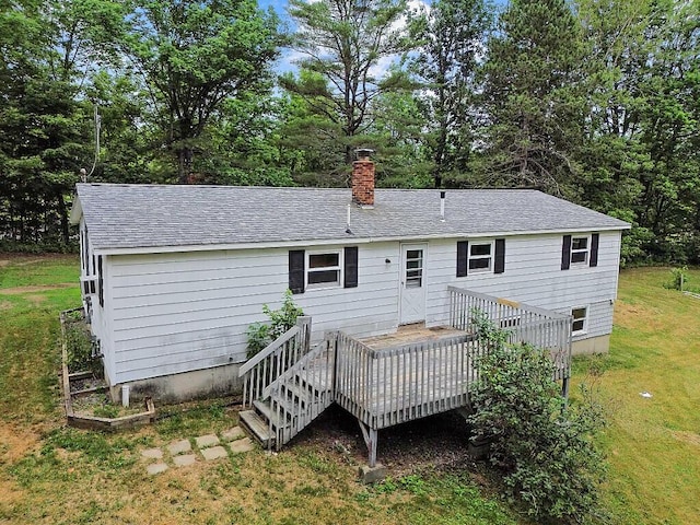 329 Reed Rd, Windsor, ME 04363 - rear view of house with a lawn, a deck, a chimney, view of scattered trees, and a shingled roof