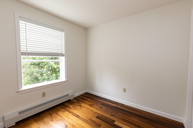 13 Bremen St, Westbrook, ME 04092 - empty room featuring a baseboard heating unit and wood finished floors